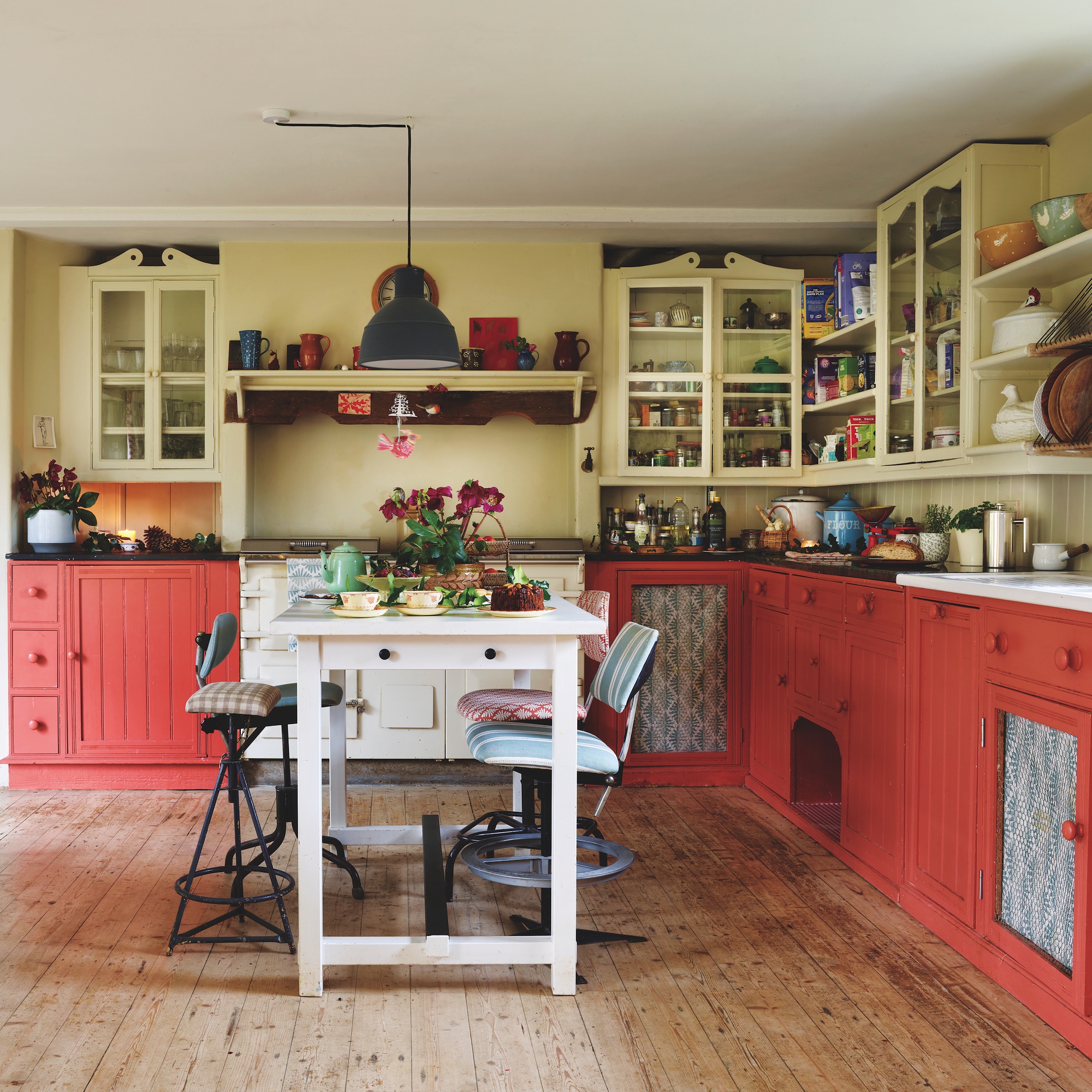 kitchen with peach painted cabinets and white island unit
