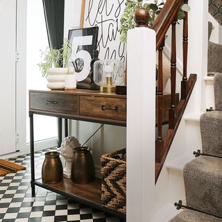 neutral hallway with black and white flooring