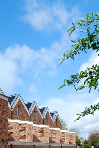 heritage mews interiors and exterior showing dressed home with white walls and brick exterior