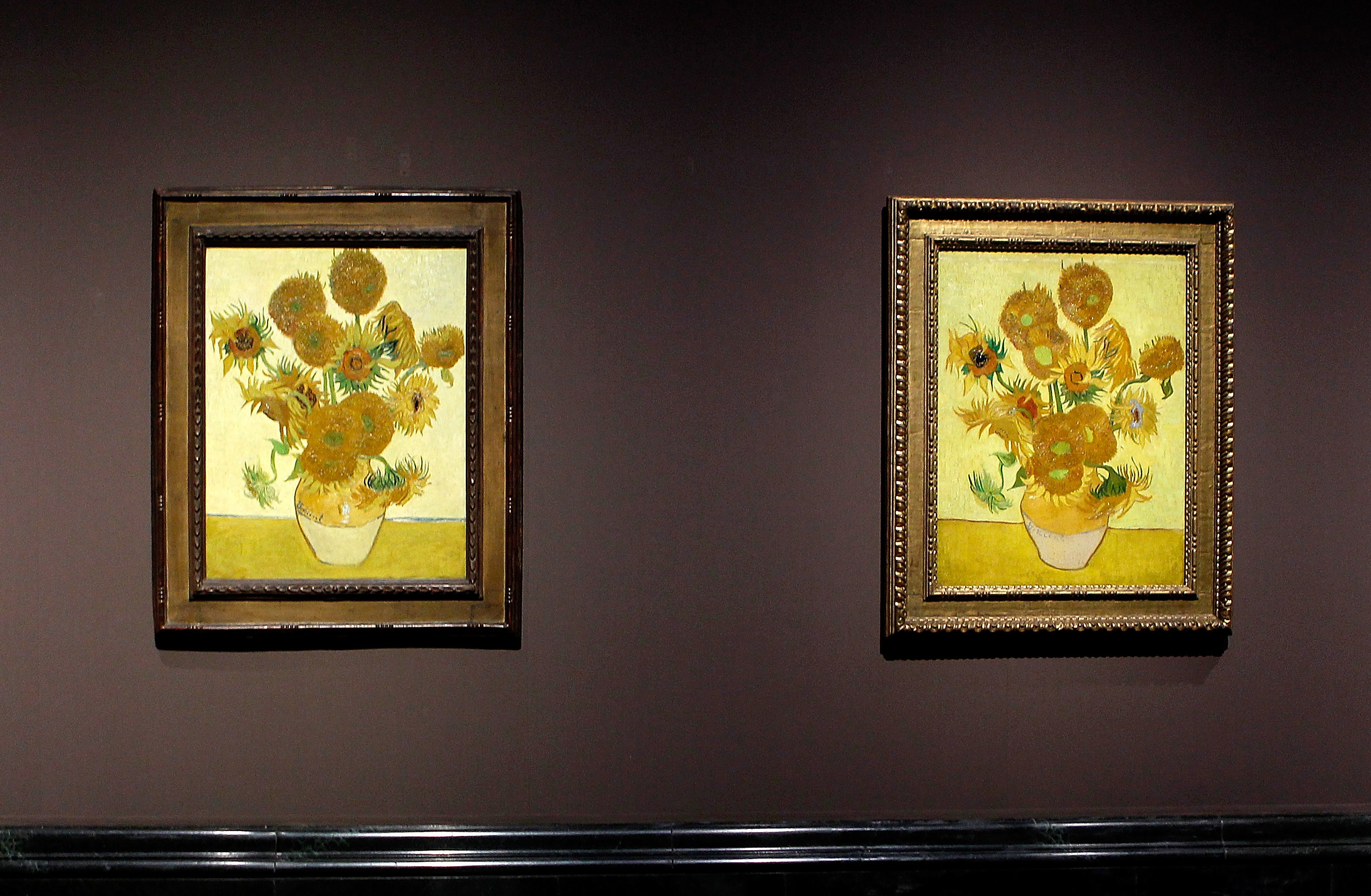 Photo of the paintings Sunflowers by Van Gogh hanging on a wall