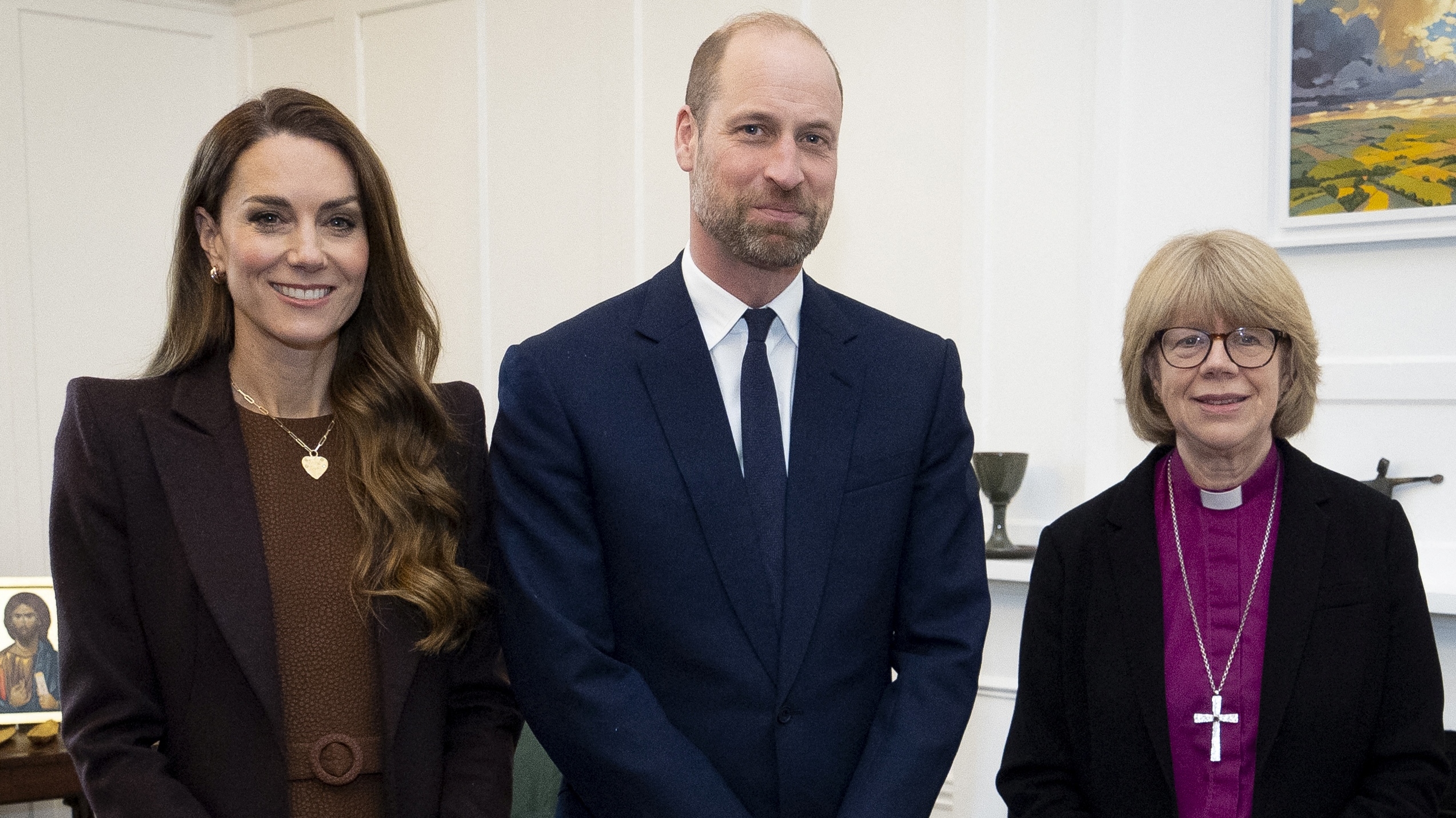 Prince William (C), Prince of Wales and Catherine (L), Princess of Wales pose with the Archbishop of Canterbury Sarah Mullally (R) during an audience in the archbishop's study at Lambeth Palace in London on February 5, 2026