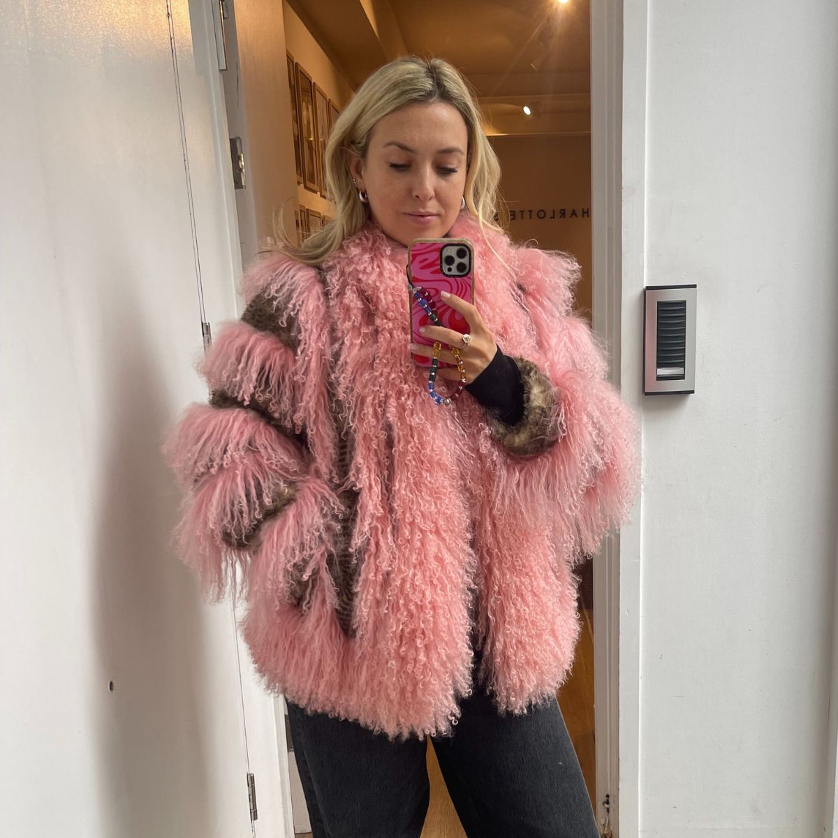 Clementina Jackson wears a pink faux fur coat by charlotte simone