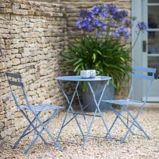 Dorset Blue Rive Driote table and chairs bistro set in courtyard