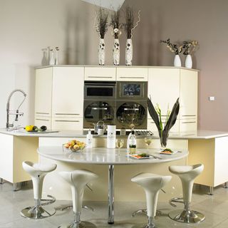 room with white round table with stools