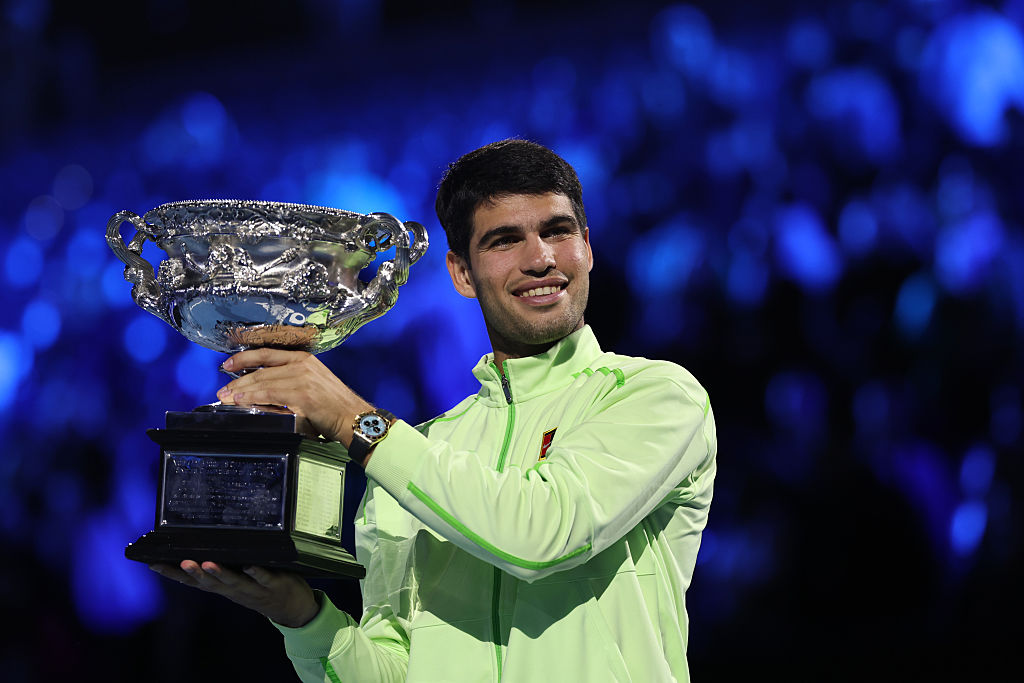 On February 1, 2026, at just 22 years old, Spaniard Carlos Alcaraz won the Australian Open, making him the youngest to complete a career Grand Slam. Here poses with the Norman Brookes Challenge Cup at the presentation ceremony after his victory in the Men's Singles Final against Novak Djokovic of Serbia at Melbourne Park in Melbourne, Australia.