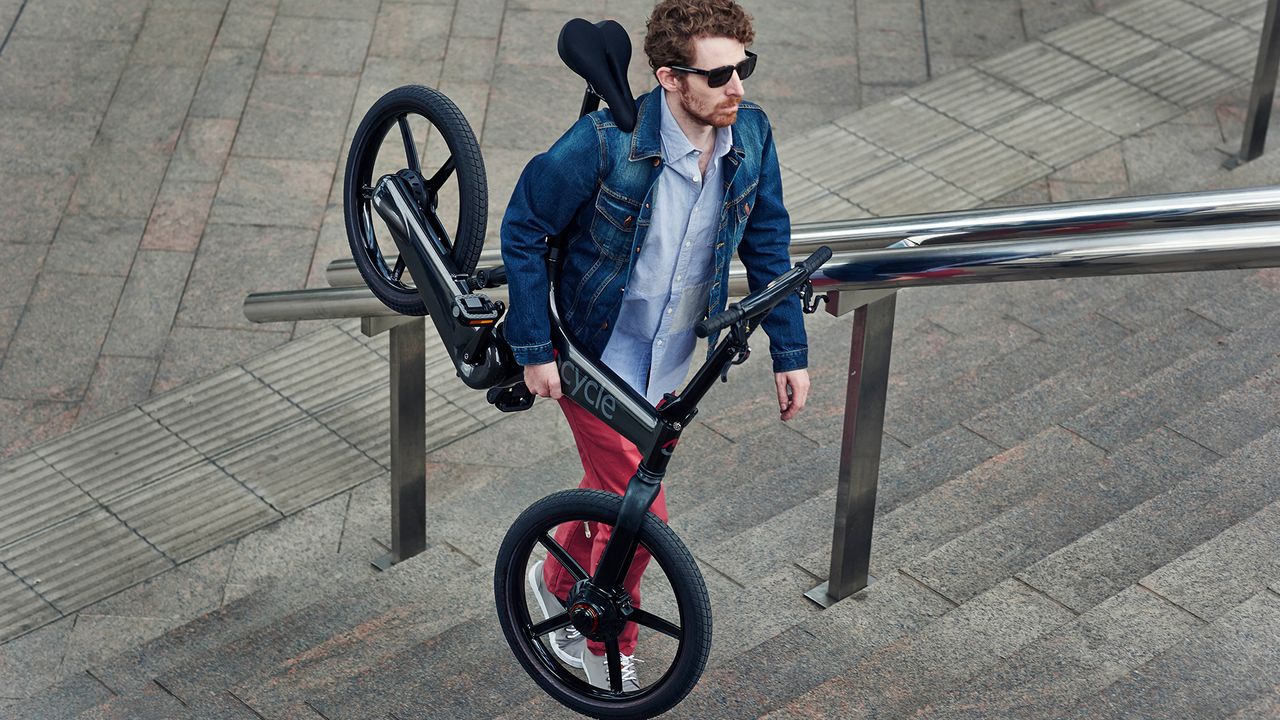 Hipster struggling to carry bike