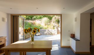 dining room with view through bifold doors to patio