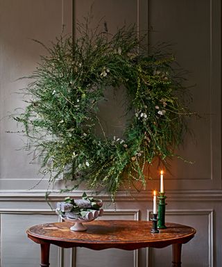 Oversized wreath on the wall with the table