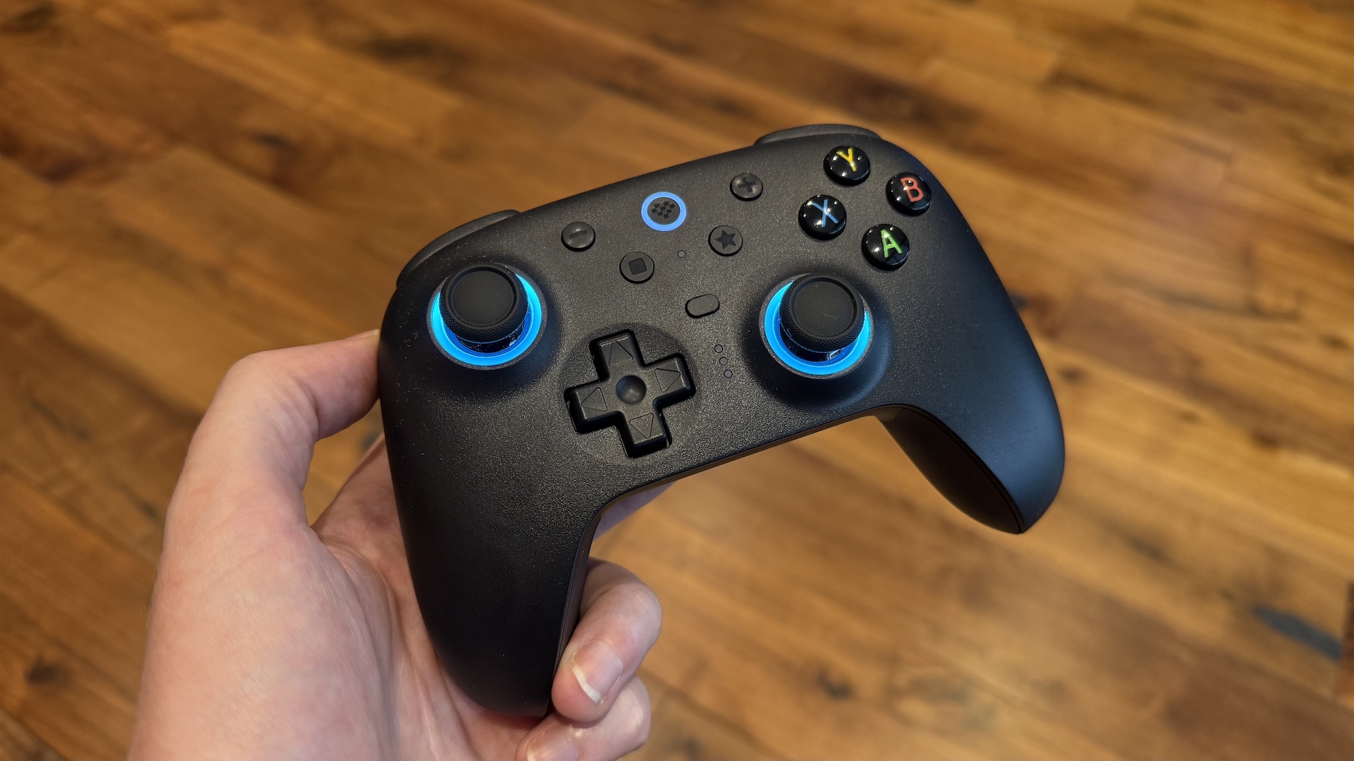 The 8BitDo Ultimate 2 controller, with dock and USB connection at home