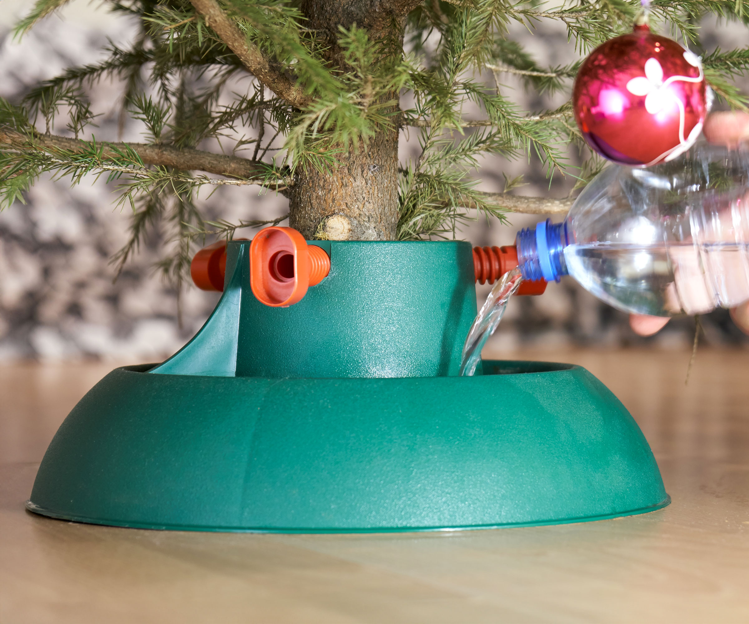 pouring fresh water into Christmas tree stand