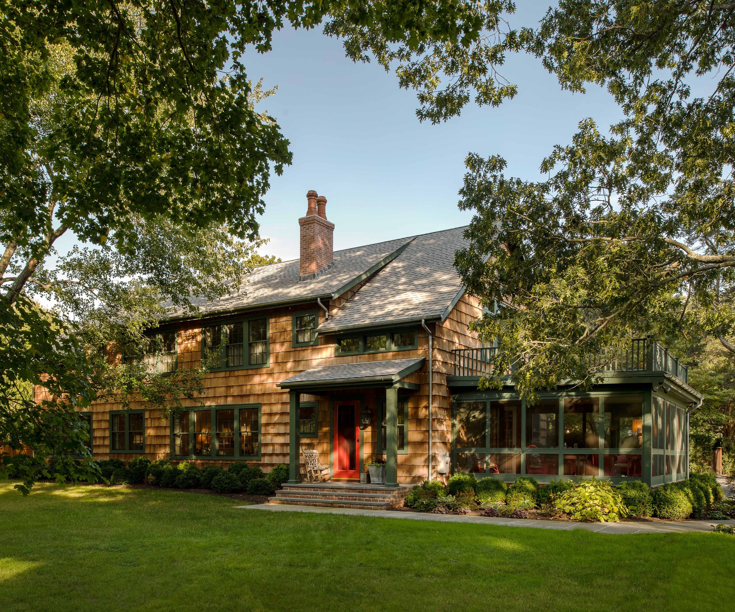 Cedar clad home with trim painted in Benjamin Moore Backwoods CC-630 green