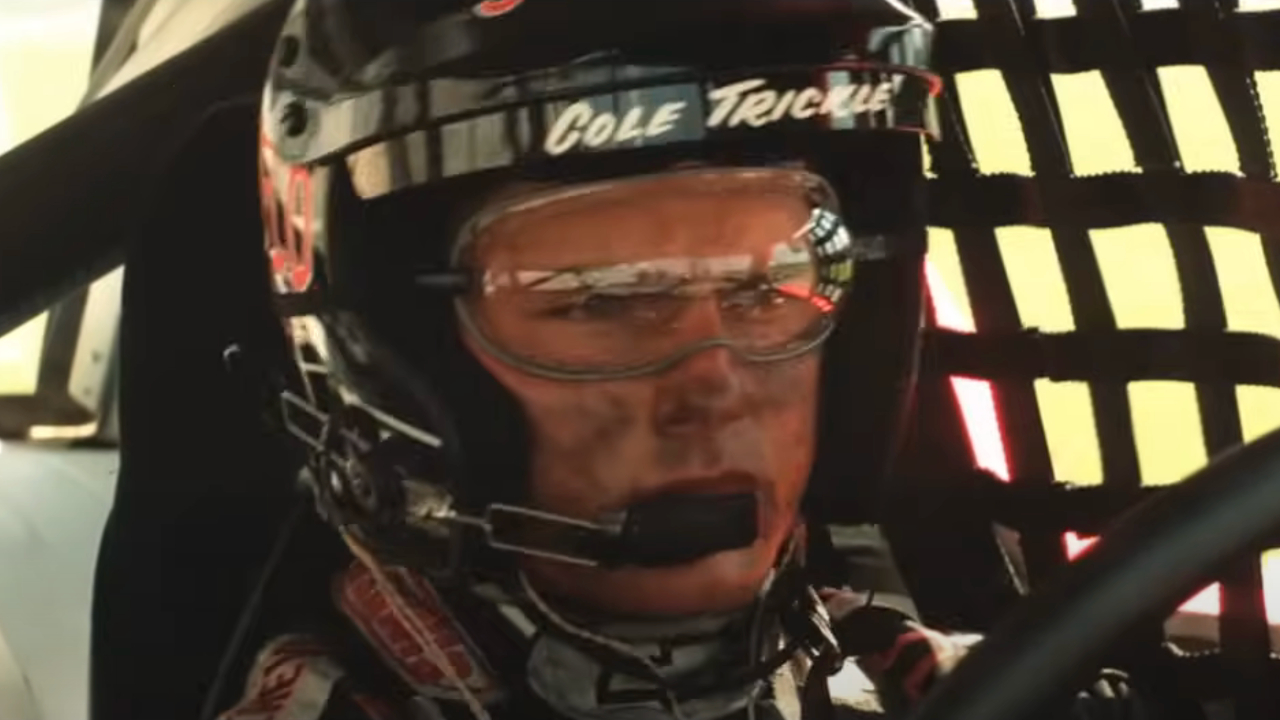 Tom Cruise concentrates as he sits behind the wheel of a race car in Days of Thunder.