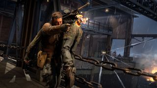 The protagonist of Sniper Elite: Resistance fires a weapon while carrying a body over his shoulder.