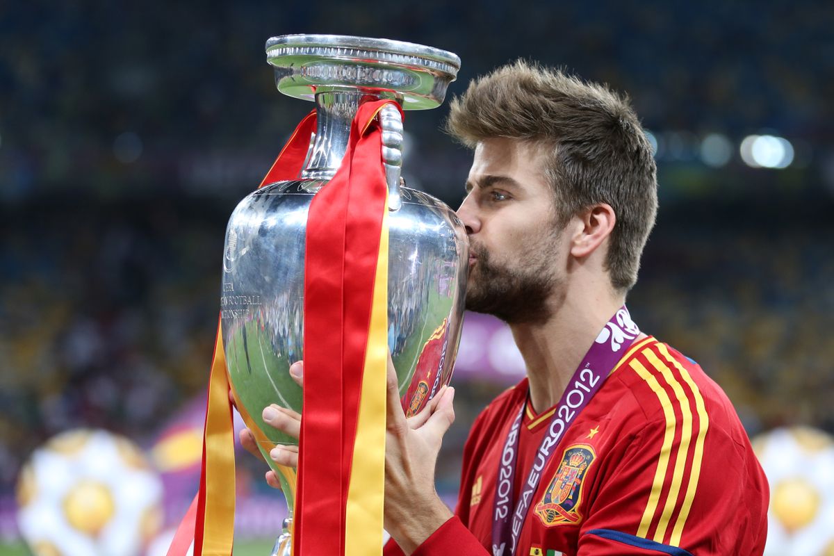 Barcelona star Gerard Pique kisses the Euro 2012 trophy after Spain&#039;s win over Italy.