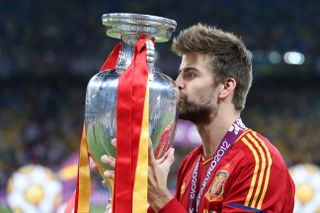 Barcelona star Gerard Pique kisses the Euro 2012 trophy after Spain's win over Italy.