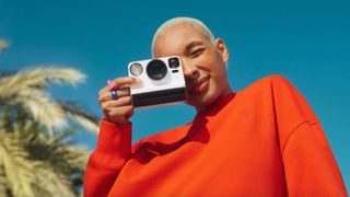 A person holding a Polaroid Now Gen 2 camera