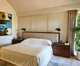 bedroom with panels and abstract art