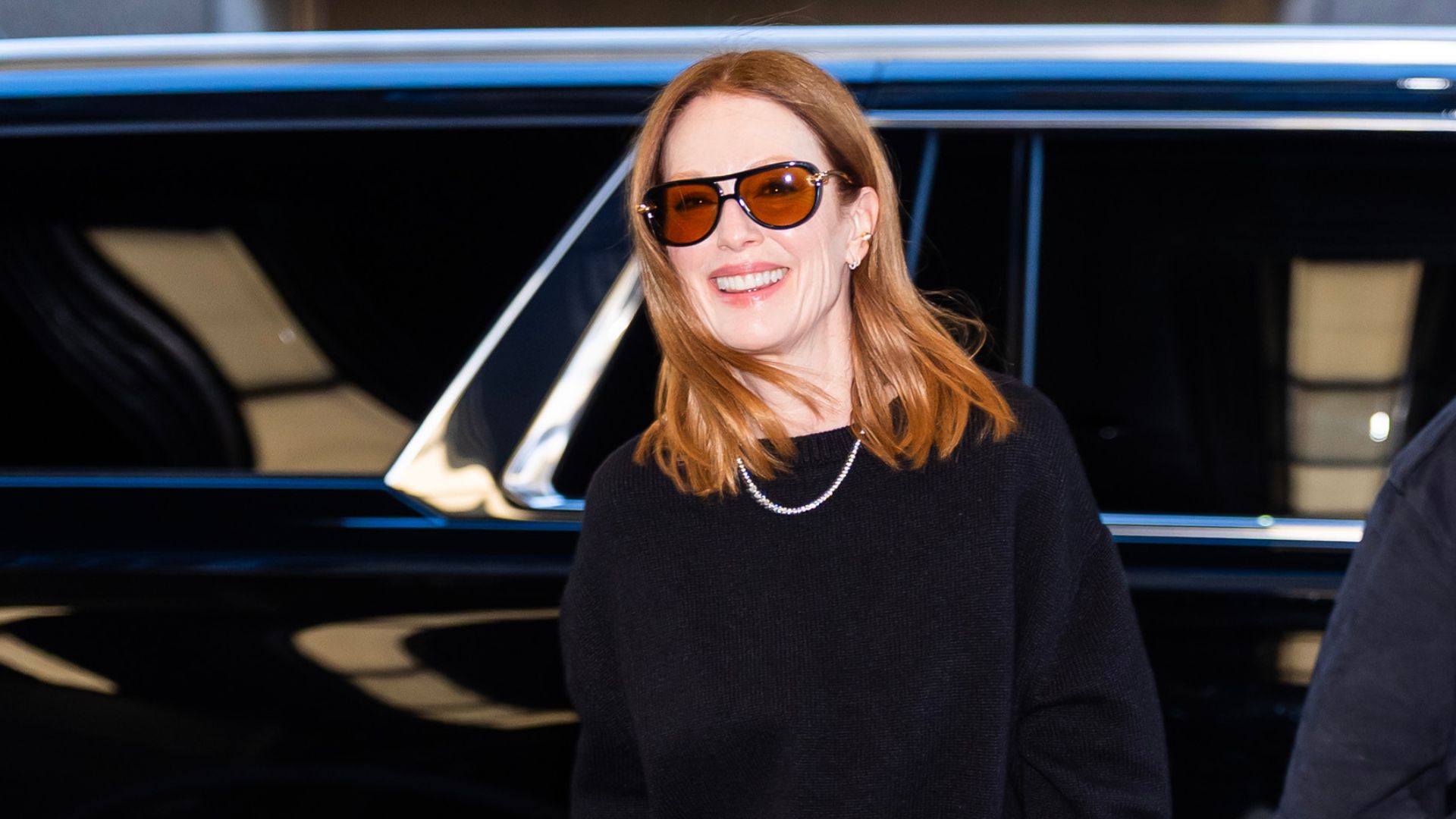 a headshot of julianne moore wearing sunglasses