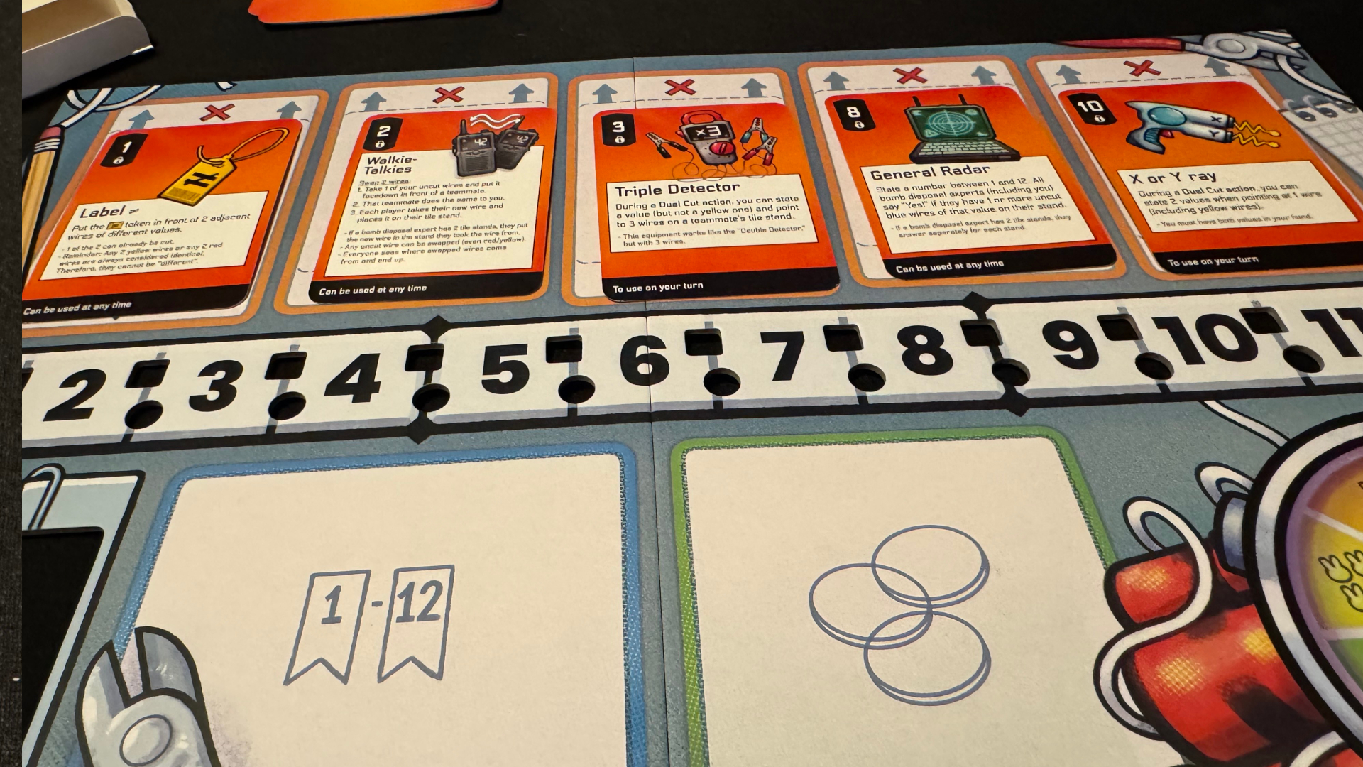 The Bomb Busters board with cards visible along the top row, above a row of numbers