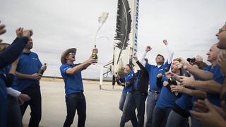 Blue Origin billionaire founder Jeff Bezos (Amazon.com's CEO) and team members celebrate after the successful first spaceflight and landing of its New Shepard spacecraft and booster. The test flight launched from West Texas on Nov. 23, 2015.