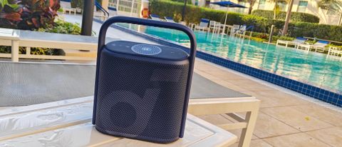 Anker Soundcore Motion X500 on a table near an outside pool