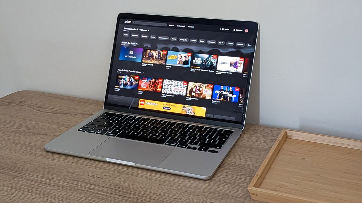 A laptop on a table showing a Plex video library