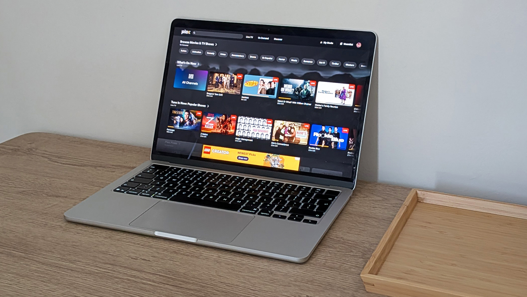 A laptop on a table showing a Plex video library