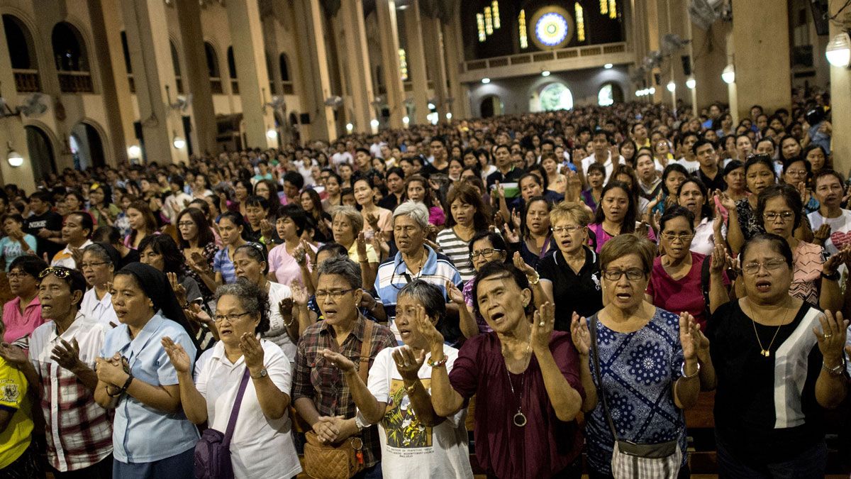 Churchgoers attend a mass in Manila condemning extra judicial killings under new President Rodrigo Duterte