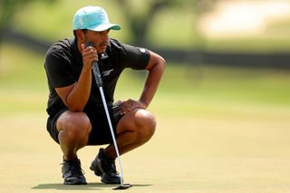 Munoz lines up a putt on the green