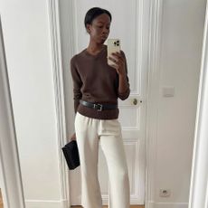 A French woman in a brown sweater