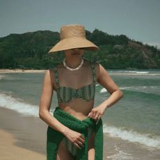 Dawn wearing green bikini