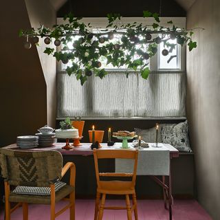 dining table with ivy filled branch above