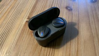 The Beyerdynamic Free Byrd earbuds in their charging case with lights on