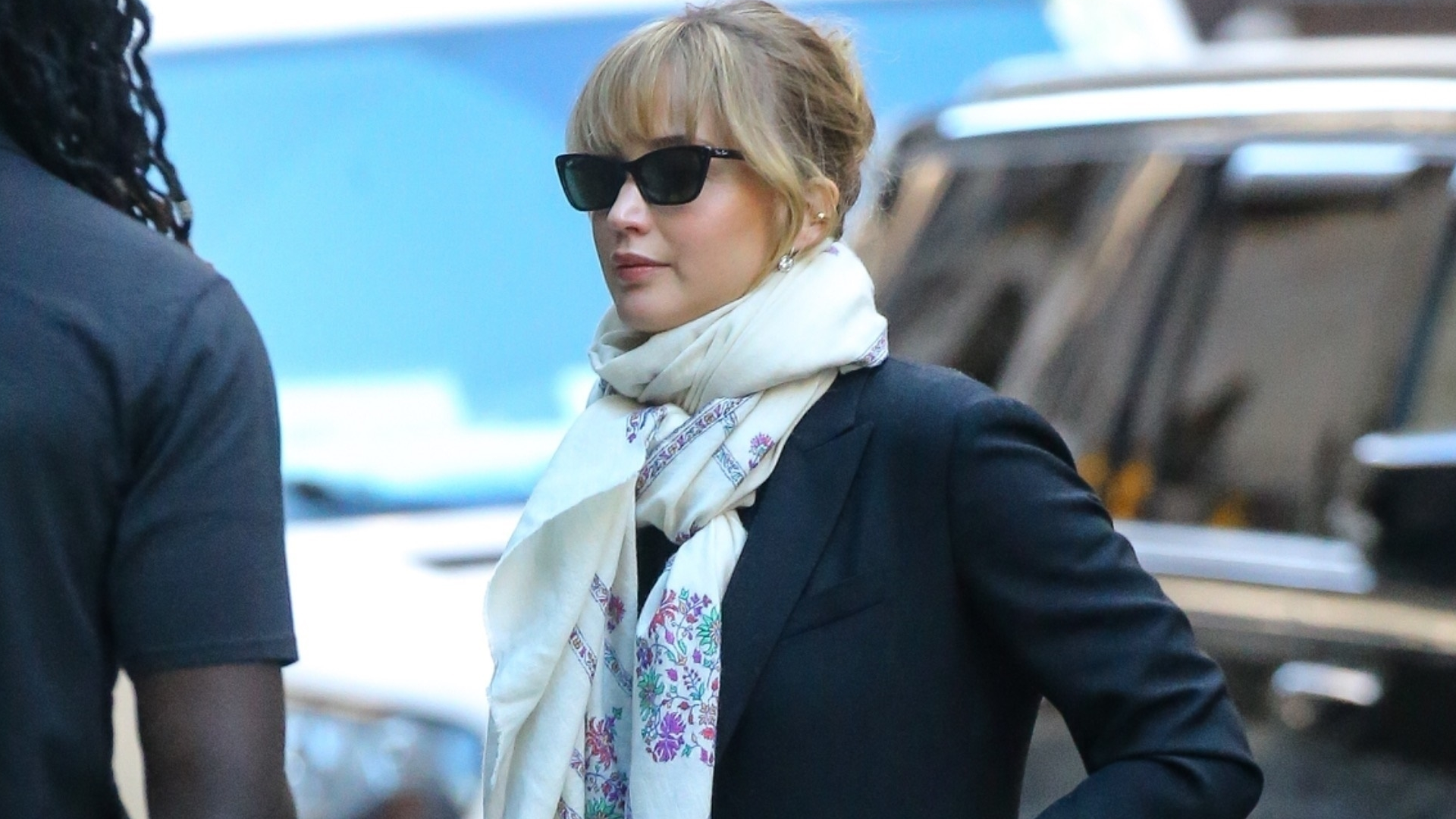 Jennifer Lawrence was spotted in New York wearing a patterned black maxi dress, a black coat, a white scarf, and patent leather boots