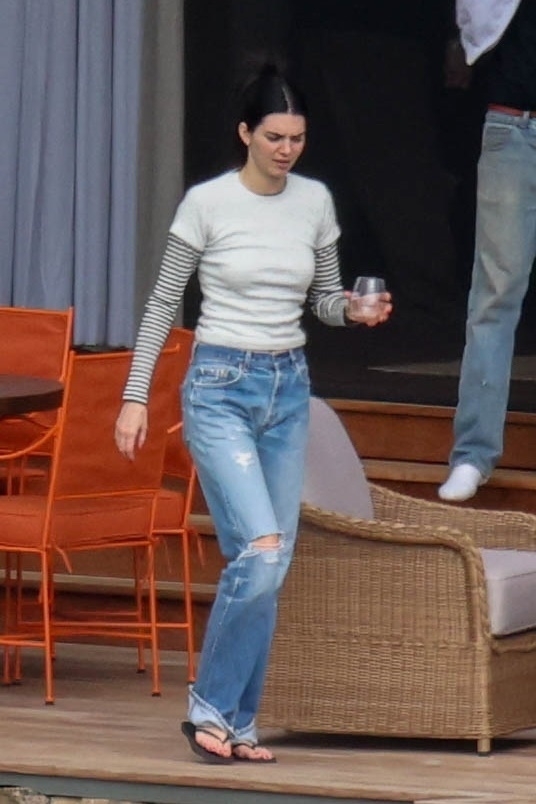 Kendall Jenner pulls off the divisive flip-flops with jeans combo, inspired by The Row Spring 2025.