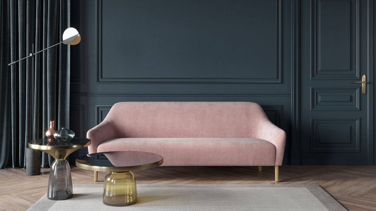 Royal blue painted wall with blush pink sofa