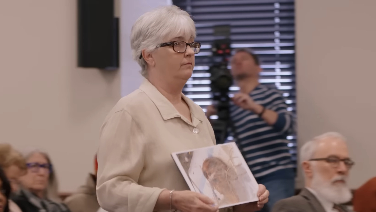Sondra Ray holding a picture of her son, Steven Davis, in The Alabama Solution