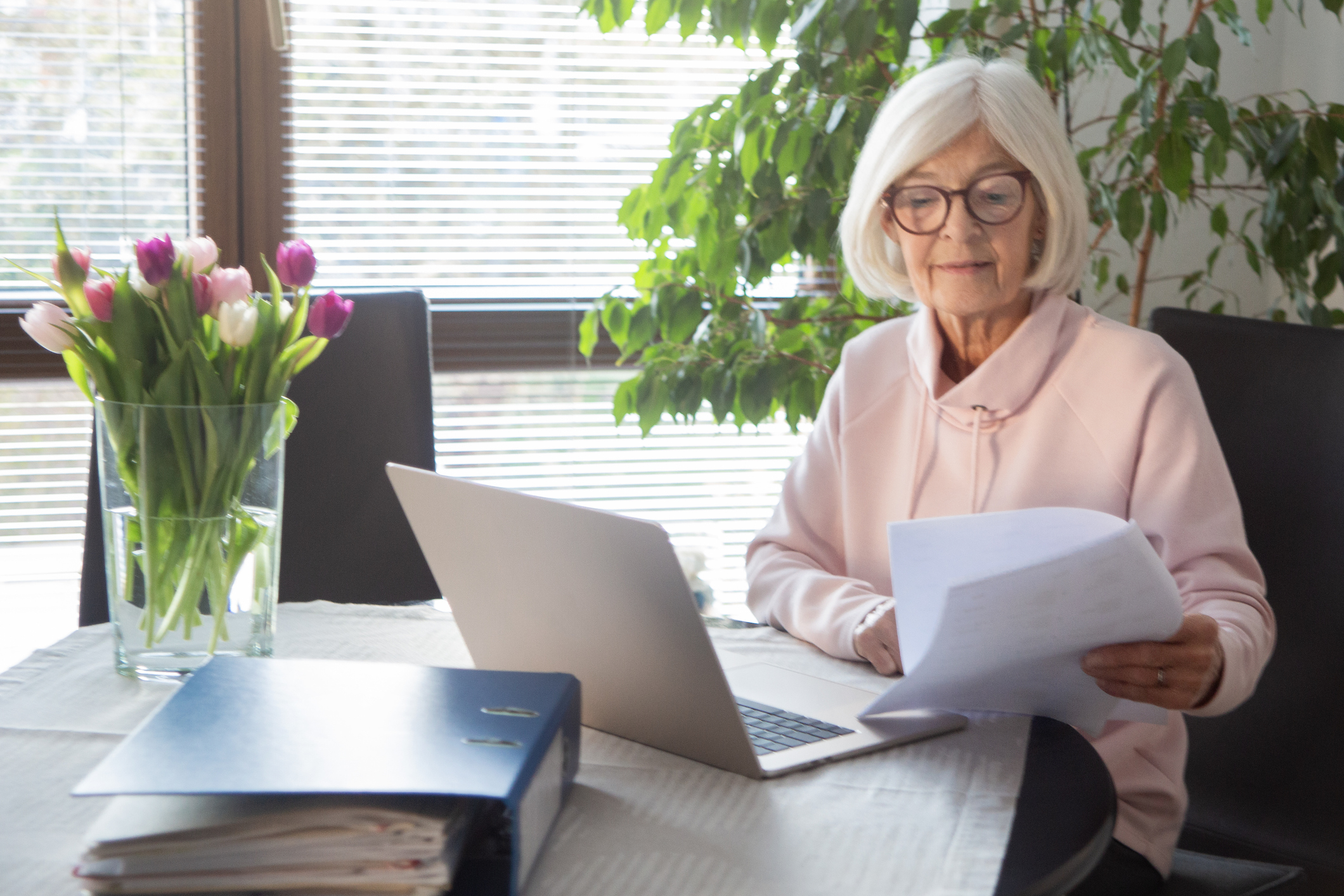 A mature woman uses a laptop to plan for retirement.