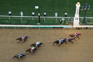 Rich Strike with Sonny Leon up (R) crosses the finish line to win ahead of Epicenter (C) causing a huge shock and Zandon (L) during the 148th running of the Kentucky Derby at Churchill Downs on May 07, 2022