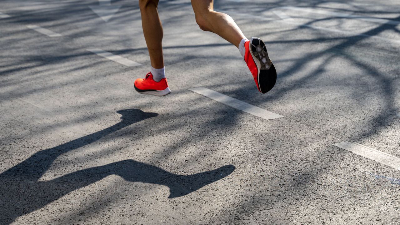 A person&#039;s lower legs and feet as they run.