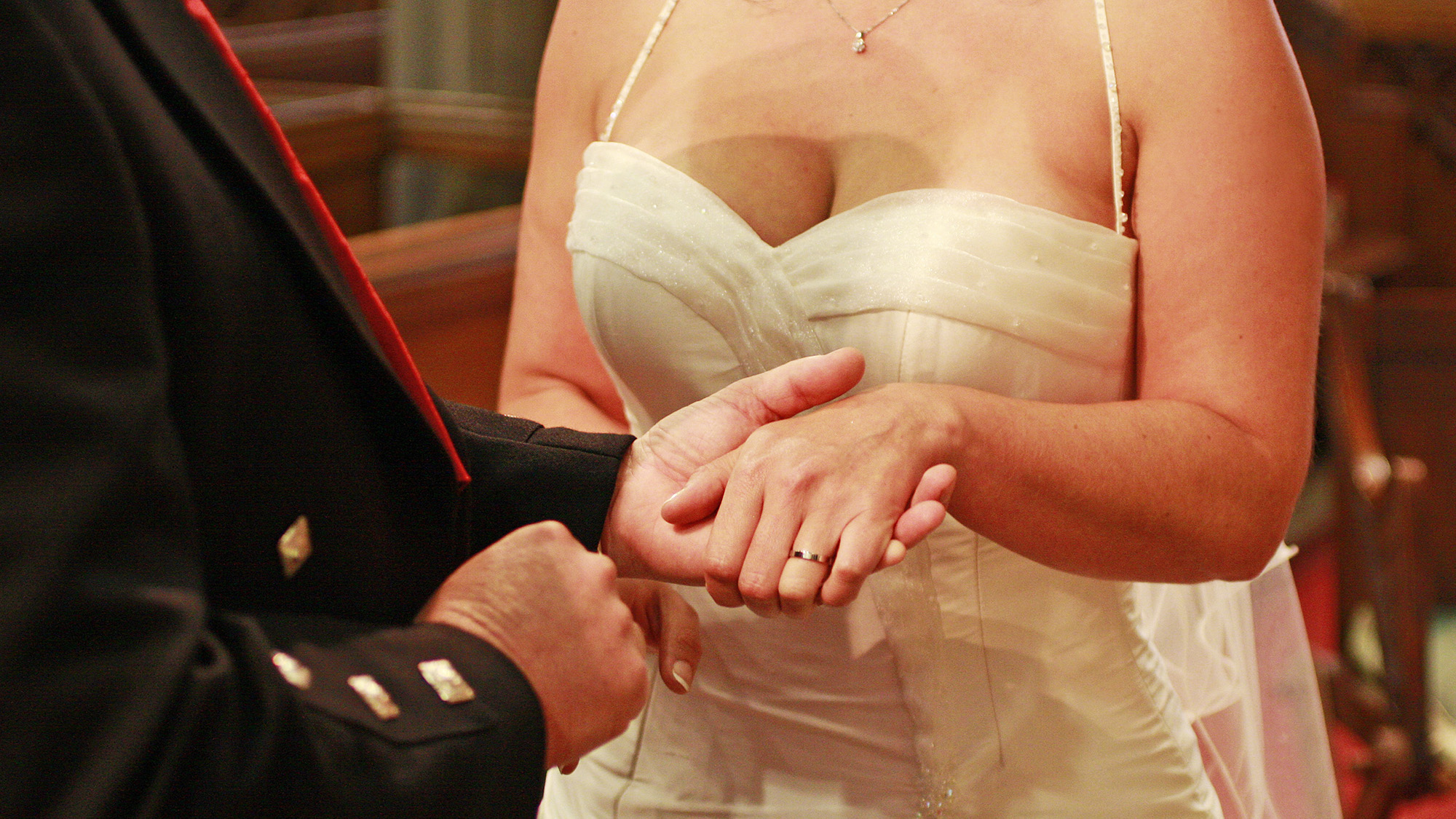 The ring being placed on the finger in a wedding ceremony