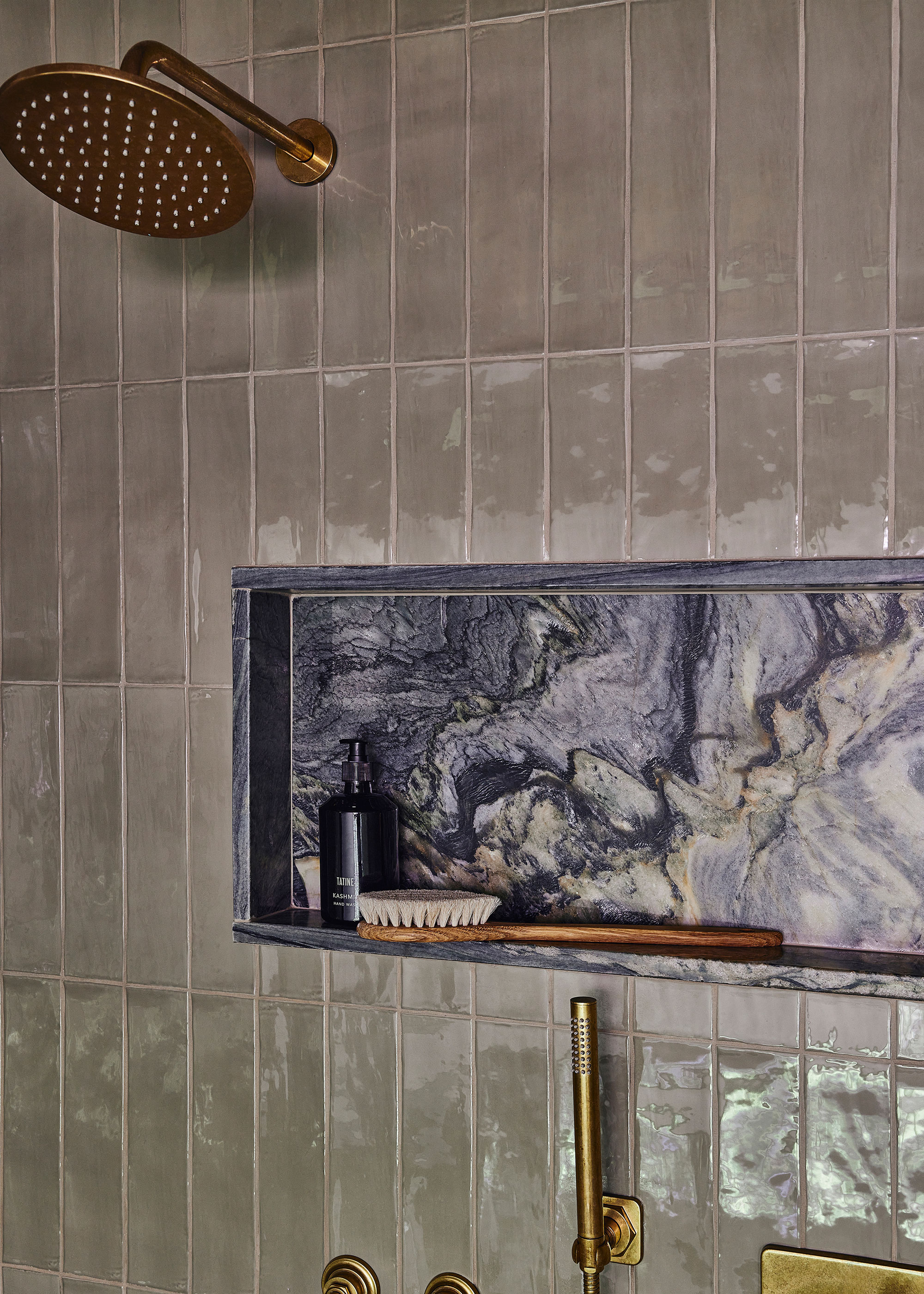 brass rain shower in shower enclosure with alcove storage