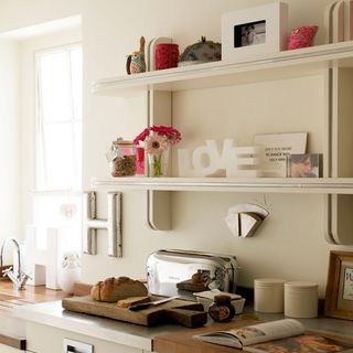 kitchen with white walls and shelf on wall