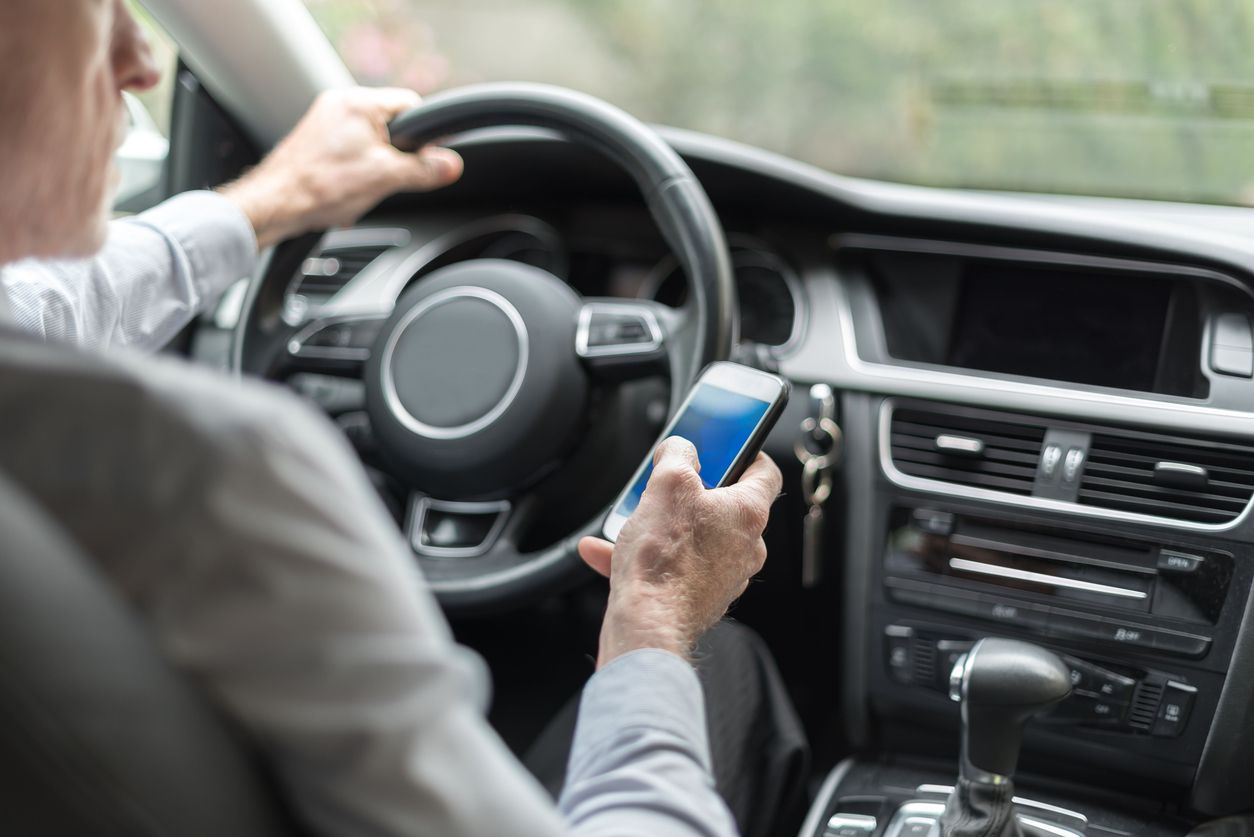 A man texting and driving.