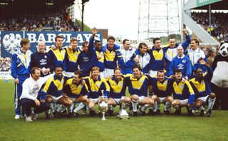 Leeds United players and coaching staff pose with the First Division trophy at Elland Road in 1992.