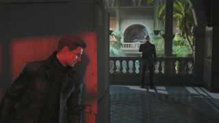Bond peeks around a corner at a guard in 007 First Light