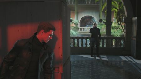 Bond peeks around a corner at a guard in 007 First Light