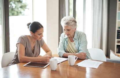 mother and daughter reviewing a letter