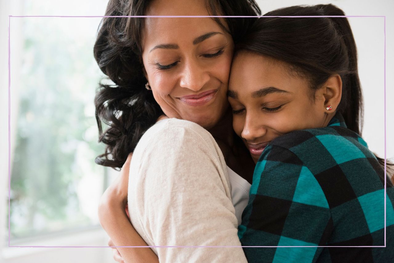 A mother and teenage daughter hugging