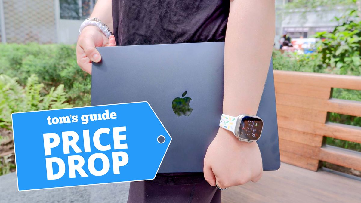 Man holding a 15-inch MacBook Air with lid closed